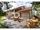 Rear exterior view of the home featuring an outdoor patio with a built-in fire pit and outdoor furniture at 1425 Autumnwood Ln, Evergreen, CO 80439