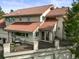 Stunning multi-level house featuring a terracotta roof, balcony, and well-manicured landscaping at 1425 Autumnwood Ln, Evergreen, CO 80439