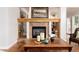 Elegant fireplace with decorative mantel, tile surround, and built-in shelving at 1425 Autumnwood Ln, Evergreen, CO 80439
