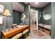 Dark green foyer showcasing the mirror, table with lamps, and a bench seat at 1425 Autumnwood Ln, Evergreen, CO 80439