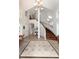 Grand foyer with high ceilings, tile flooring, and a curved staircase with wood treads at 1425 Autumnwood Ln, Evergreen, CO 80439