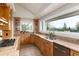 Bright kitchen features custom wood cabinets, granite countertops and stainless steel appliances at 1425 Autumnwood Ln, Evergreen, CO 80439