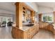 Spacious kitchen with island, custom wood cabinets and stainless steel gas cooktop at 1425 Autumnwood Ln, Evergreen, CO 80439