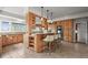 Gourmet kitchen with custom cabinets, granite counters, and a center island with seating at 1425 Autumnwood Ln, Evergreen, CO 80439