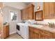 Bright laundry room with sink, cabinets and a washer and dryer at 1425 Autumnwood Ln, Evergreen, CO 80439