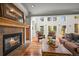 Inviting living room with a fireplace and expansive windows offering ample natural light at 1425 Autumnwood Ln, Evergreen, CO 80439
