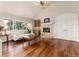 Cozy living room with a fireplace, hardwood floors, and a wet bar for entertaining at 1425 Autumnwood Ln, Evergreen, CO 80439