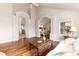 Bright living room featuring hardwood floors, arched doorways, and views into adjacent rooms at 1425 Autumnwood Ln, Evergreen, CO 80439