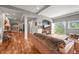 Bright living room with hardwood floors, an outdoor view, and open archways at 1425 Autumnwood Ln, Evergreen, CO 80439