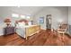 Comfortable main bedroom with hardwood floors, white bedding, and a walk-in closet at 1425 Autumnwood Ln, Evergreen, CO 80439
