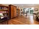 Bright home office with hardwood floors, built-in bookcases, and scenic outdoor views at 1425 Autumnwood Ln, Evergreen, CO 80439
