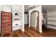 Spacious walk-in closet with custom shelving, wood floors, and a large decorative mirror at 1425 Autumnwood Ln, Evergreen, CO 80439