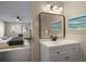 Well-lit bathroom with a vanity and view into the Primary bedroom at 775 S Alton Way # 5B, Denver, CO 80247