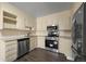 Kitchen featuring stainless steel appliances, light colored cabinetry, and wooden floors at 775 S Alton Way # 5B, Denver, CO 80247