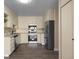 Well-lit kitchen with stainless steel appliances, light colored cabinets, and wooden floors at 775 S Alton Way # 5B, Denver, CO 80247