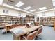 Community library with bookshelves, reading table and chairs at 775 S Alton Way # 5B, Denver, CO 80247