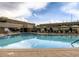 Outdoor pool with lounge chairs, umbrellas and building in the background at 775 S Alton Way # 5B, Denver, CO 80247