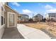 Backyard area boasting concrete patio, decorative rock landscaping, and wooden fence at 23596 E Piccolo Dr, Aurora, CO 80016