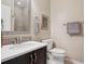Bathroom featuring a sink, vanity, and toilet with tiled floors and modern fixtures at 9528 Pendio Ct, Highlands Ranch, CO 80126