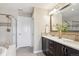This bright bathroom features double vanity sinks with elegant cabinetry, a soaking tub and glass shower at 9528 Pendio Ct, Highlands Ranch, CO 80126