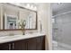 Bathroom with double sinks, granite countertop, modern fixtures, and a separate shower at 9528 Pendio Ct, Highlands Ranch, CO 80126