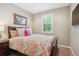 Bedroom featuring a queen-sized bed with bright, patterned bedding and a window at 9528 Pendio Ct, Highlands Ranch, CO 80126