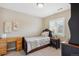 The bedroom features neutral walls, shuttered windows, and a cozy bed with patterned bedding and a nightstand at 9528 Pendio Ct, Highlands Ranch, CO 80126