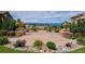 Lovely courtyard with decorative planters, manicured landscaping, and stunning views of the mountains at 9528 Pendio Ct, Highlands Ranch, CO 80126
