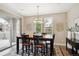 Bright dining area with large windows and sliding door, adjacent to the kitchen at 9528 Pendio Ct, Highlands Ranch, CO 80126