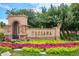 View of neighborhood entrance with colorful flowers, bushes, and landscaping at 9528 Pendio Ct, Highlands Ranch, CO 80126