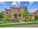 Exterior of the property with stone accents, a covered porch, and manicured landscaping at 9528 Pendio Ct, Highlands Ranch, CO 80126
