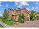 Exterior view of home with a two-car garage, and landscaped front yard at 9528 Pendio Ct, Highlands Ranch, CO 80126