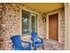Front porch featuring brick and blue chairs at 9528 Pendio Ct, Highlands Ranch, CO 80126