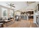Spacious living room flows into an open kitchen with breakfast bar and modern appliances at 9528 Pendio Ct, Highlands Ranch, CO 80126