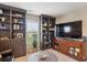 A beautifully designed living space with custom built-in bookshelves and entertainment center, perfect for relaxation at 9528 Pendio Ct, Highlands Ranch, CO 80126