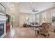 Open concept living room boasts high ceilings, abundant natural light, and a cozy fireplace at 9528 Pendio Ct, Highlands Ranch, CO 80126