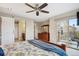 A spacious primary bedroom features a slider to a private balcony and en-suite bath with barn-door entry at 9528 Pendio Ct, Highlands Ranch, CO 80126