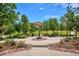 A beautiful park-like setting with benches, landscaping, fountain and walking path on a sunny day at 9528 Pendio Ct, Highlands Ranch, CO 80126