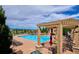 Community pool with lounge chairs, umbrellas, and scenic views in the background at 9528 Pendio Ct, Highlands Ranch, CO 80126