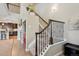 Elegant staircase with wrought iron railing connecting multiple levels of the home at 9528 Pendio Ct, Highlands Ranch, CO 80126
