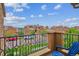 Enjoy the neighborhood views from this home's private balcony with wrought-iron railings and a blue deck chair at 9528 Pendio Ct, Highlands Ranch, CO 80126