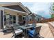 This covered back porch offers a fire pit, outdoor seating and lights for entertaining at 2209 Lupine Pl, Erie, CO 80516
