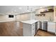 Open basement with white kitchen, wood flooring, stainless steel appliances, and great lighting at 2209 Lupine Pl, Erie, CO 80516