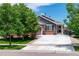 Charming single-story home with manicured lawn, two-car garage, and inviting front porch at 2209 Lupine Pl, Erie, CO 80516