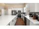 Stylish kitchen featuring stainless steel appliances, white cabinets, and a large island with seating at 2209 Lupine Pl, Erie, CO 80516