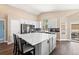 Spacious kitchen with a large center island, white countertops, stainless steel appliances, and ample cabinet space at 2209 Lupine Pl, Erie, CO 80516