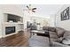 Inviting living room boasting hardwood floors, a fireplace, a comfortable gray sectional, and an open layout at 2209 Lupine Pl, Erie, CO 80516