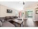 Comfortable living room with a large sectional, hardwood floors, and a view to the front entryway at 2209 Lupine Pl, Erie, CO 80516