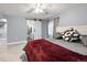 Comfortable main bedroom features a ceiling fan, two windows, and a barn door leading to the ensuite bathroom at 2209 Lupine Pl, Erie, CO 80516