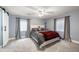 Cozy main bedroom features a ceiling fan, two windows, a barn door and a large bed at 2209 Lupine Pl, Erie, CO 80516